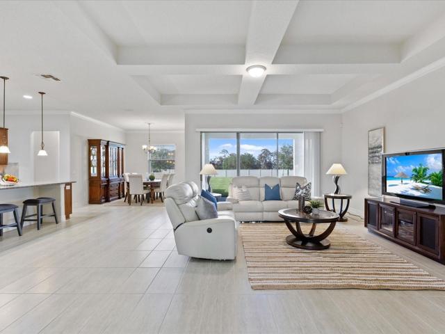 Stunning living room area with tray ceilings and crossbeams.