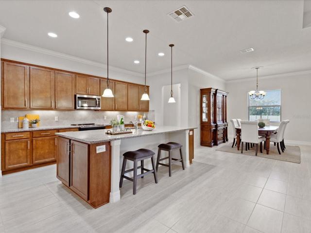 Impeccable kitchen with oversized island, plenty of cabinet space, and all stainless steel appliances.