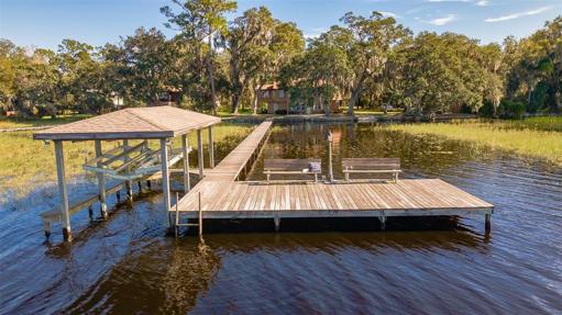 Aerial view of the wood dock, covered boatlift and deck.