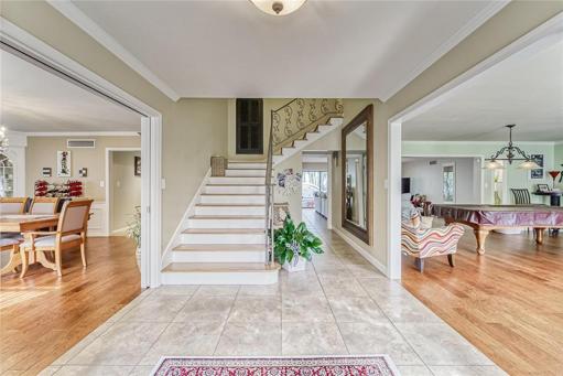 Traditional Style Home with Large Foyer, Sweeping Staircase and Formal Living Room with Fireplace and Formal Dining Room 