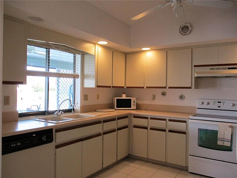 Kitchen window overlooking pool and canal