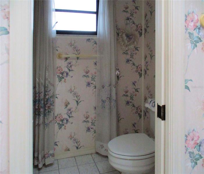 Private water closet with pocket doors and linen closet