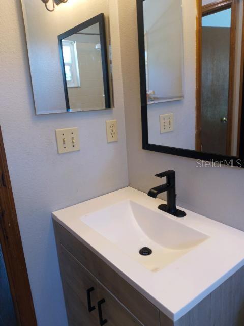 Updated sink and cabinet in guest bathroom
