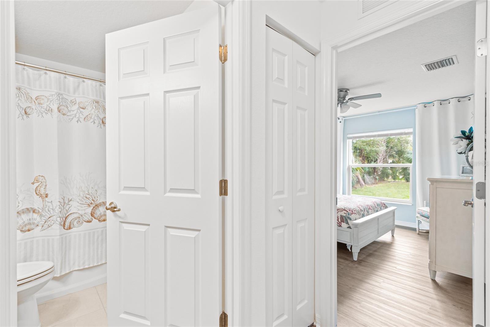 Guest bedroom 2 in main house with view into full bath/hallway.