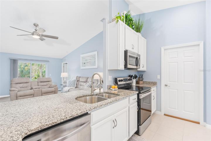 Kitchen in main house with door leading to mother-in-law suite and garage.
