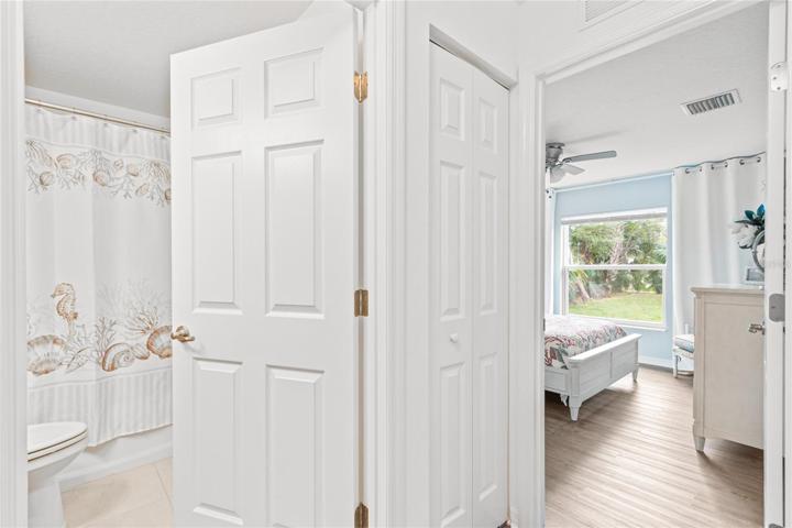 Guest bedroom 2 in main house with view into full bath/hallway.