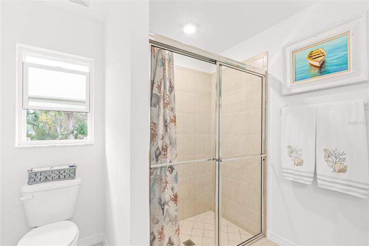 Master bath with full shower and view of water.
