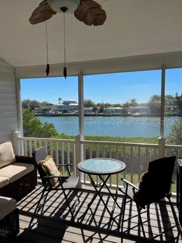 relaxing loungers in screened patio w/waterviews