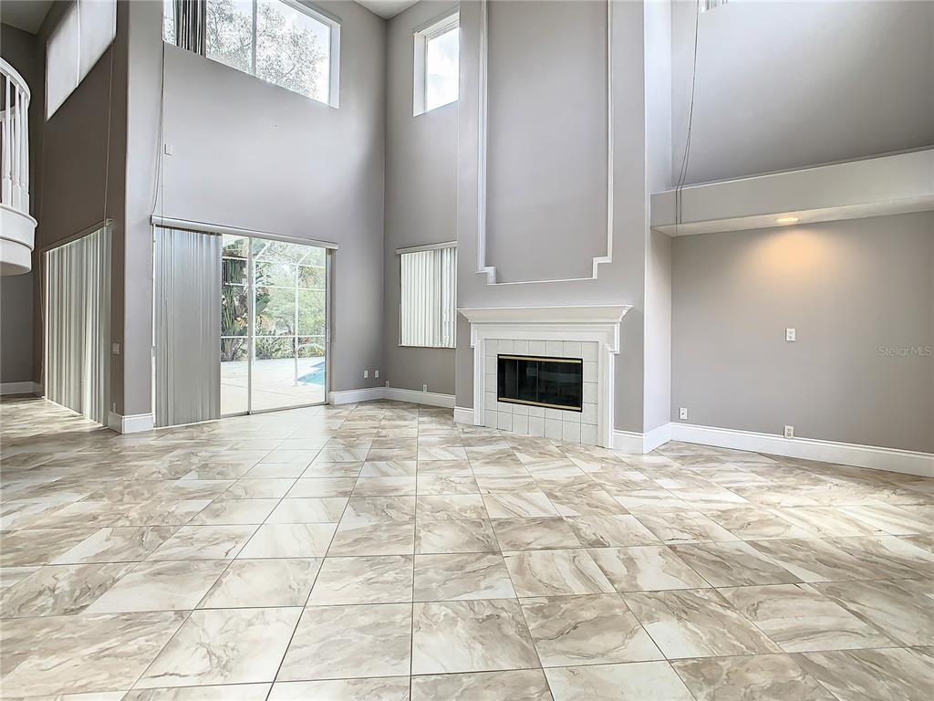 Family room, fireplace, Sliders to pool.  20 ftceiling