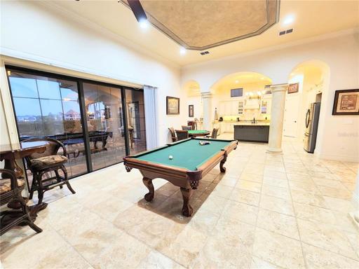 Gathering & Game Room (16x21) with 12 Ft Wide Sliding Glass Doors. View towards Kitchen