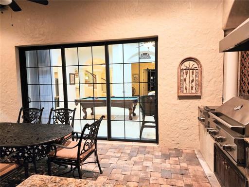 Gathering & Game Room Sliding Glass Doors Closed 12 Feet wide opens to patio lanai by Summer Kitchen