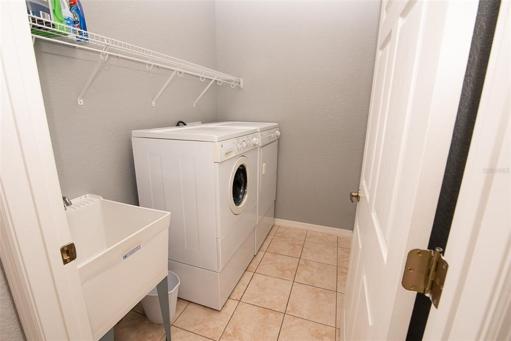 Interior laundry with washer, dryer and utility sink.