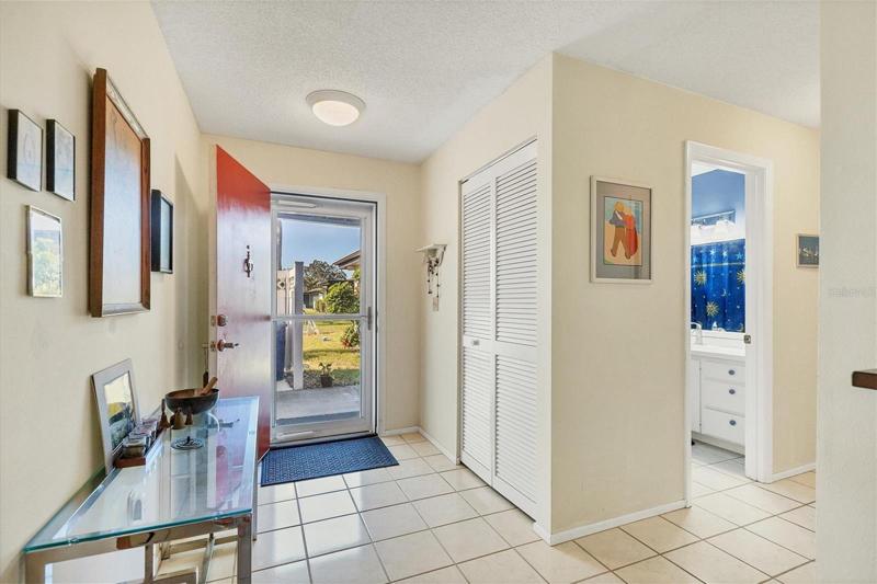Bright, inviting foyer with a hall closet.