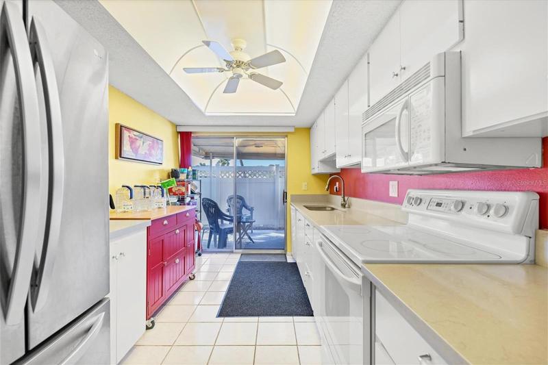 A bright, cheerful kitchen with sliding doors to a covered patio.