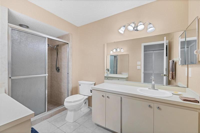 The walk-in shower has a built-in bench.