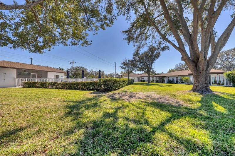 The heated, community pool is just beyond the backyard view of the home.