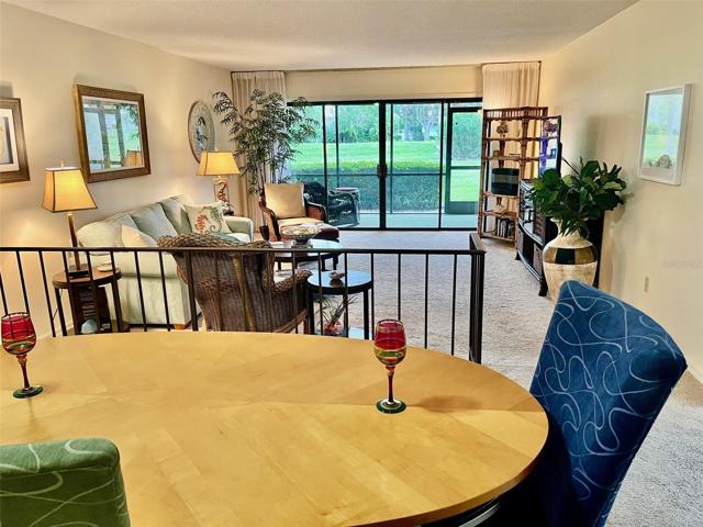 Dining room open to living room, with view thru lanai to back yard