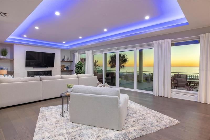 Great room with natural gas fireplace and sliding doors to the balcony with a daily view of stunning sunsets!