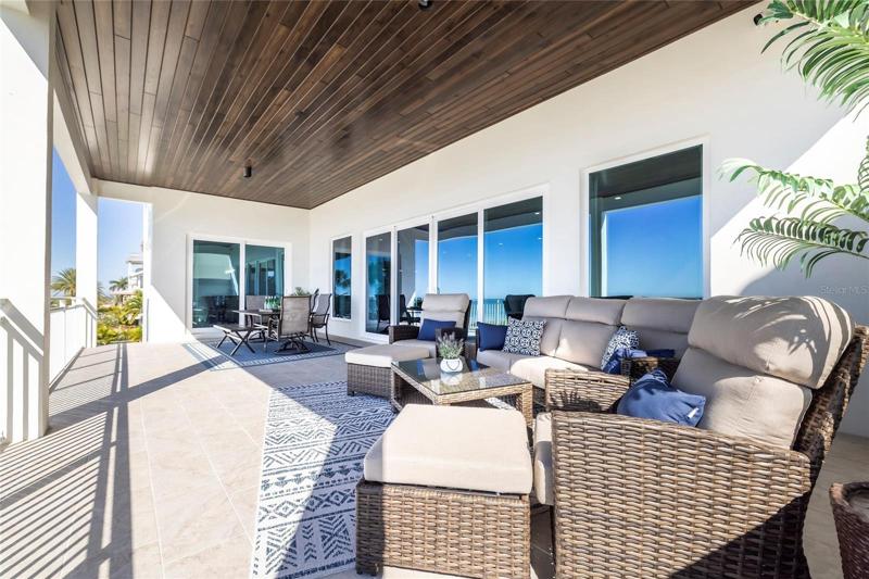 Massive balcony on second floor grand living, kitchen, and dining area.