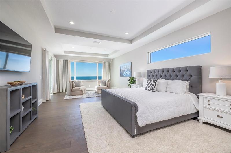 This elegant owner's suite on the third floor has sliding glass doors to the balcony, two large walk-in closets, and an equisite spa bath with a soaking tub and a grand rainshower with two rain heads.