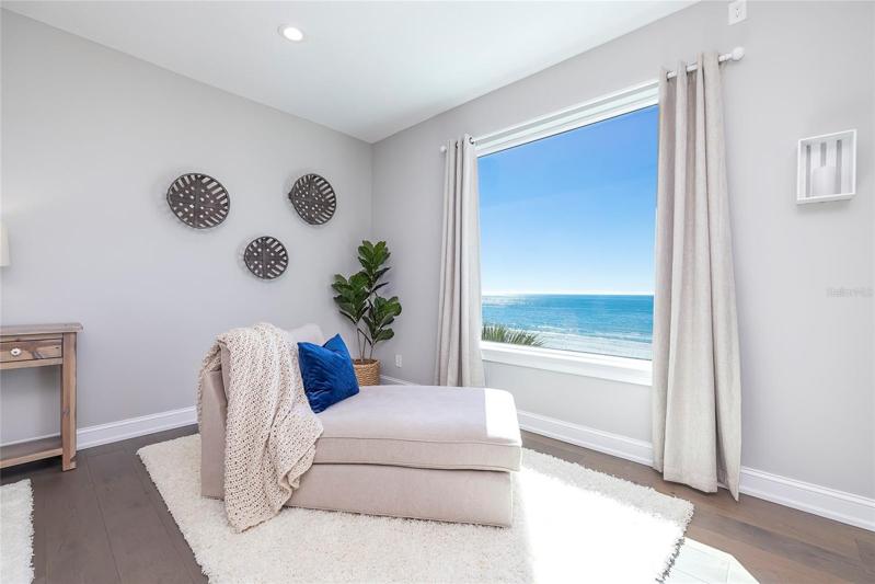 Secondary owners suite with sitting area enjoys post card views.