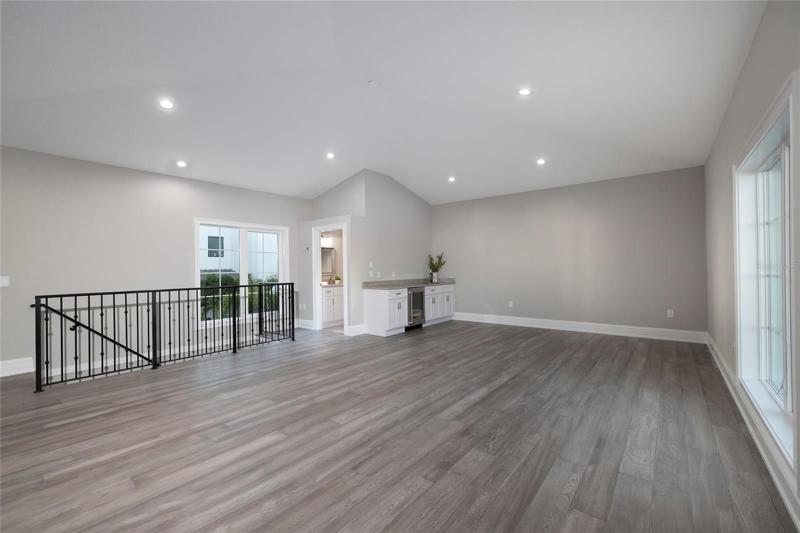 The Casita bonus room with half bath and bar with beverage refrigerator located above the detached garage.