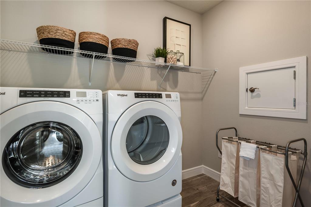 Entry from Garage and Laundry Room. Model home design. Pictures are for illustration purposes only. Elevations, colors and options may vary. Furniture is for model home only.