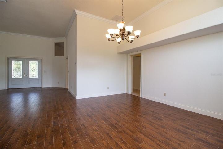 Formal Dining view toward Formal Living Room and doors to covered patio.