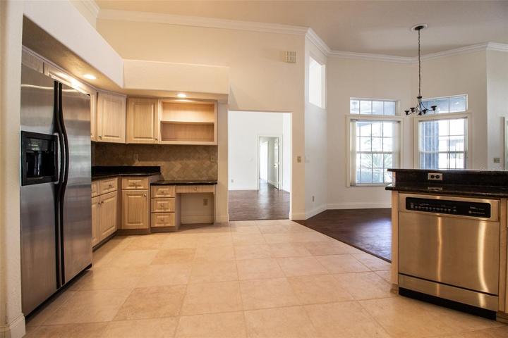 From Kitchen view toward Breakfast Area and opening to Formal Living Room and Master Bedroom door beyond.