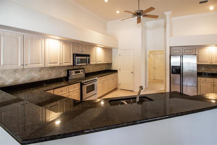 Nice stone tile backsplash, pantry closet and access to Formal Dining Room.