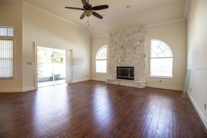 Inviting Family Room with gas fireplace, opens to covered patio thru pocketing sliders.