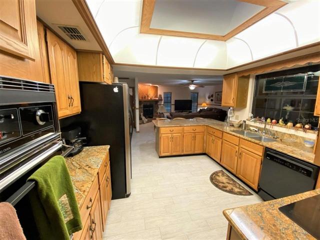 NIGHT TIME VIEW of Kitchen with solid wood cabinets, granite countertops and skylight