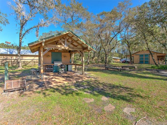 Custom Outdoor Cowboy Kitchen with bar seating. Perfect for parties, grilling & entertaining in the backyard.