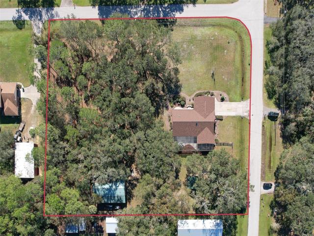 Ariel View of Property (*red boundary line is approximate) Custom Home(3 Bed/3 Bath/2 Car Garage on 2.06 acres) NEW ROOF & PAINT in 2022. Not in a Flood Zone, No HOA or CDD. Huge Pole Barn, Cowboy Kitchen, Fire Pit, Potting Shed, Vacant land & Huge Screened in Lanai.