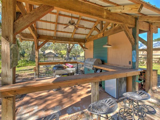 Custom Outdoor Cowboy Kitchen with bar seating. Perfect for parties, grilling & entertaining in the backyard.