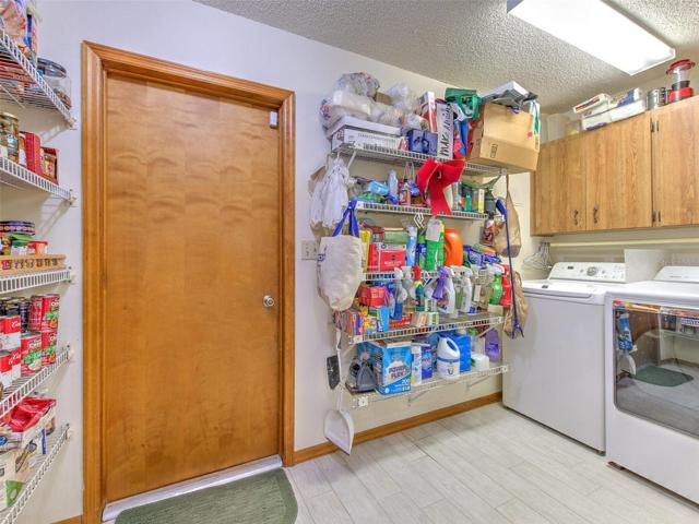 Laundry/Mud Room with storage shelves, cabinets and food pantry wall shelving.