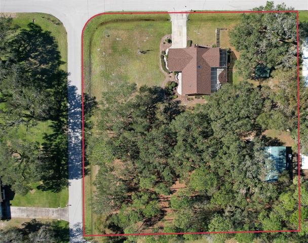 Ariel View of Property (*red boundary line is approximate) Custom Home(3 Bed/3 Bath/2 Car Garage on 2.06 acres) NEW ROOF & PAINT in 2022. Not in a Flood Zone, No HOA or CDD. Huge Pole Barn, Cowboy Kitchen, Fire Pit, Potting Shed, Vacant land & Huge Screened in Lanai.