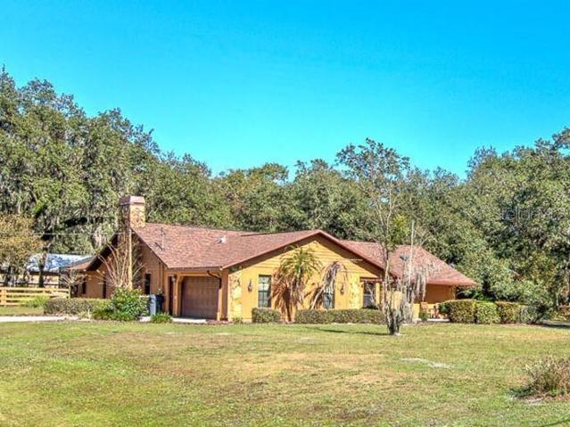 Front View. Custom Home(3 Bed/3 Bath/2 Car Garage on 2.06 acres) NEW ROOF & PAINT in 2022. Not in a Flood Zone, No HOA or CDD. Huge Pole Barn, Cowboy Kitchen, Fire Pit, Potting Shed, Vacant land & Huge Screened in Lanai.