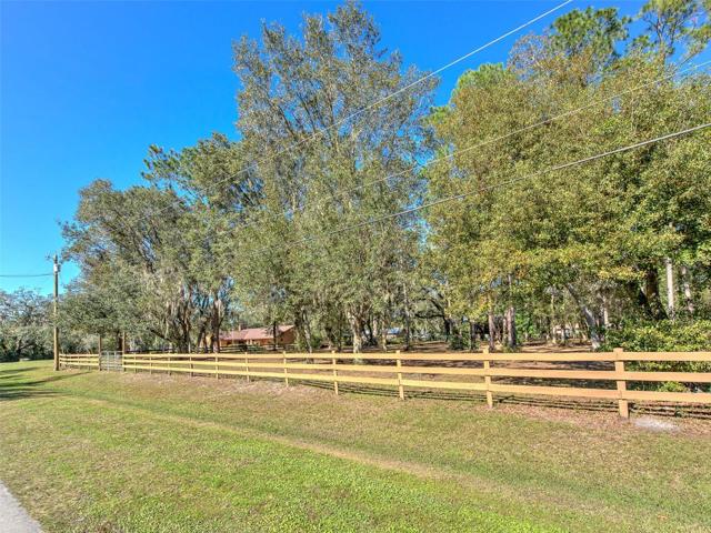 Street View of entrance to fenced & vacant side of property - PERFECT for Horses & has a POLE BARN!