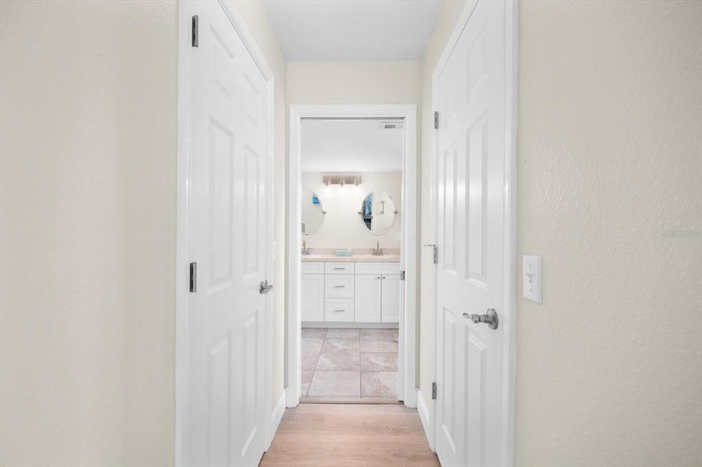 master hallway with dual walk in closets