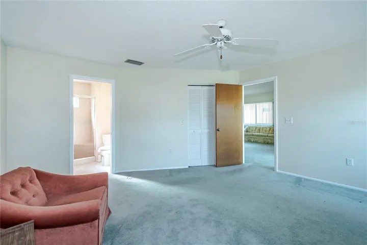 Another view of bedroom w/entrance to master bathroom, door to walk in closet and door into living roo.