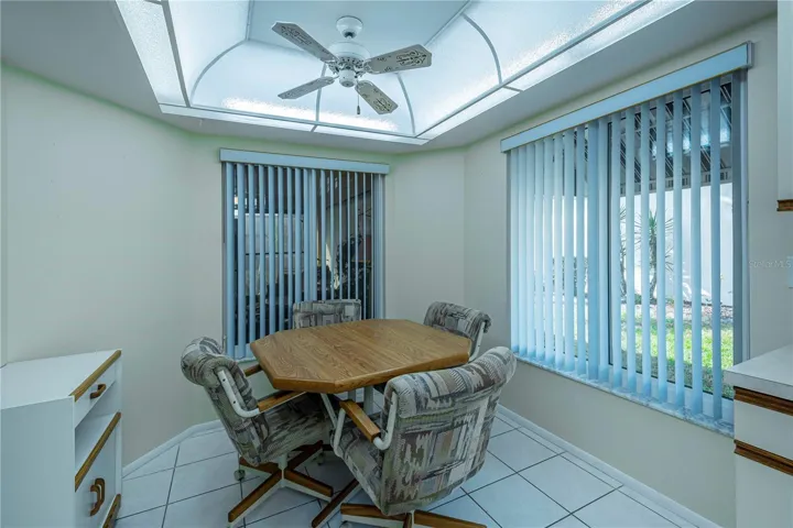 Eating area at the end of the kitchen with lots of natural light from the large windows.