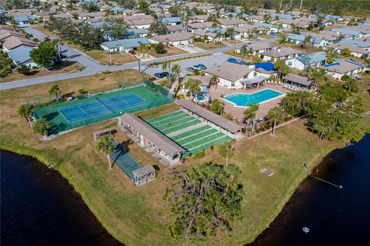 Another view of the lake, tennis court, bocce ball, shuffleboard and pool area