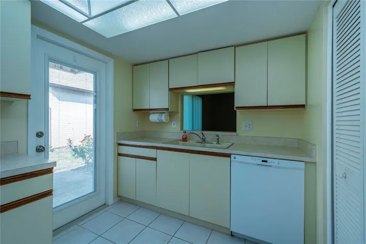 Another view of the kitchen w/a side door opening onto a patio in the side yard