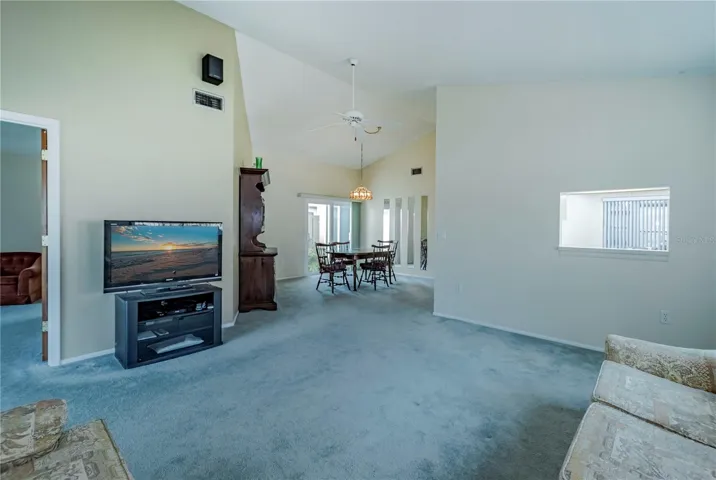 View of the large living room with opening pass through from kitchen.