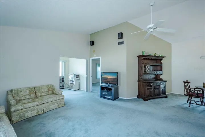 Another view of the living room with entry onto back lanai, master bedroom and the dining room
