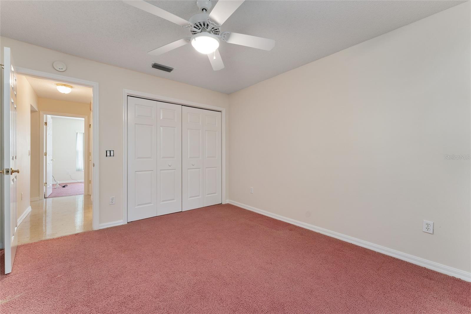 BEDROOM #2 has a CLOSET &amp; CEILING FAN w/ light. Guest wing hallway on L.