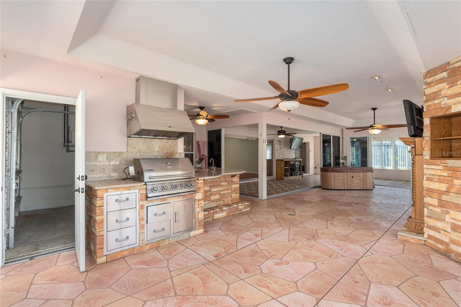 SCREEN ENCLOSED LANAI has an adjacent 9'7" X 9'7" STORAGE AREA behind a 6' GARAGE DOOR (far L)