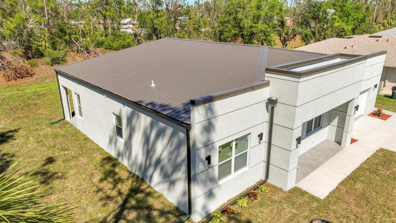 PITCHED METAL ROOF FOR GOOD DRAINAGE AND LONG LASTING.