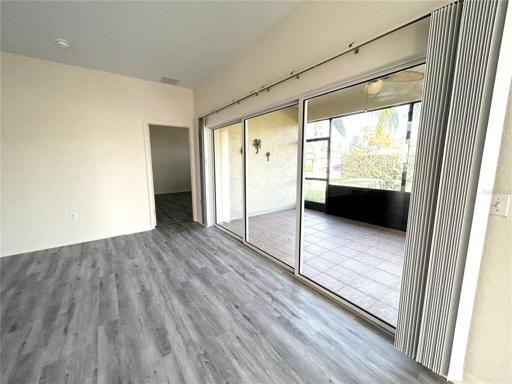 Living room looking out to lanai with triple sliding doors